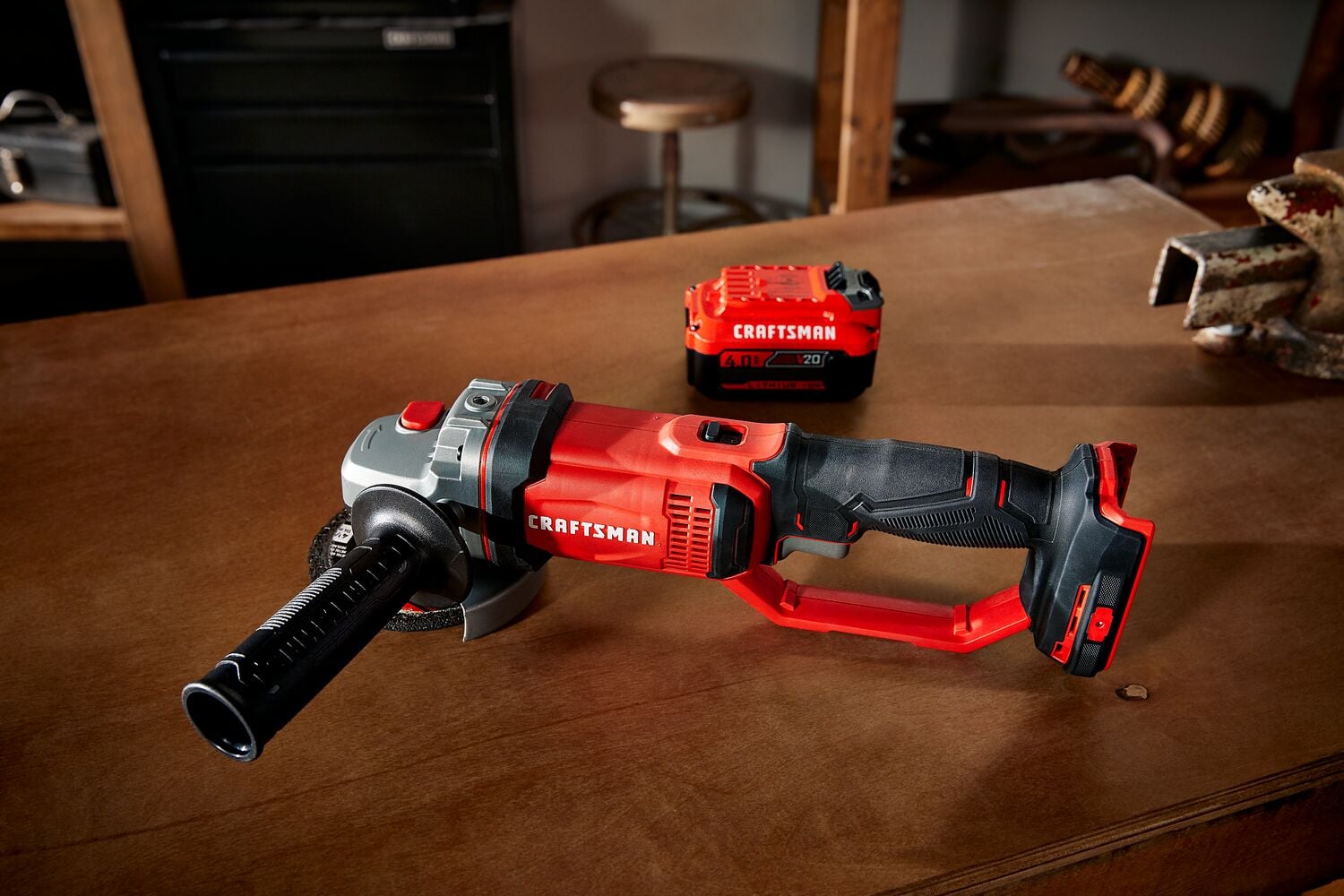 Cordless 4 and half inch small angle grinder kit 1 battery placed on table.