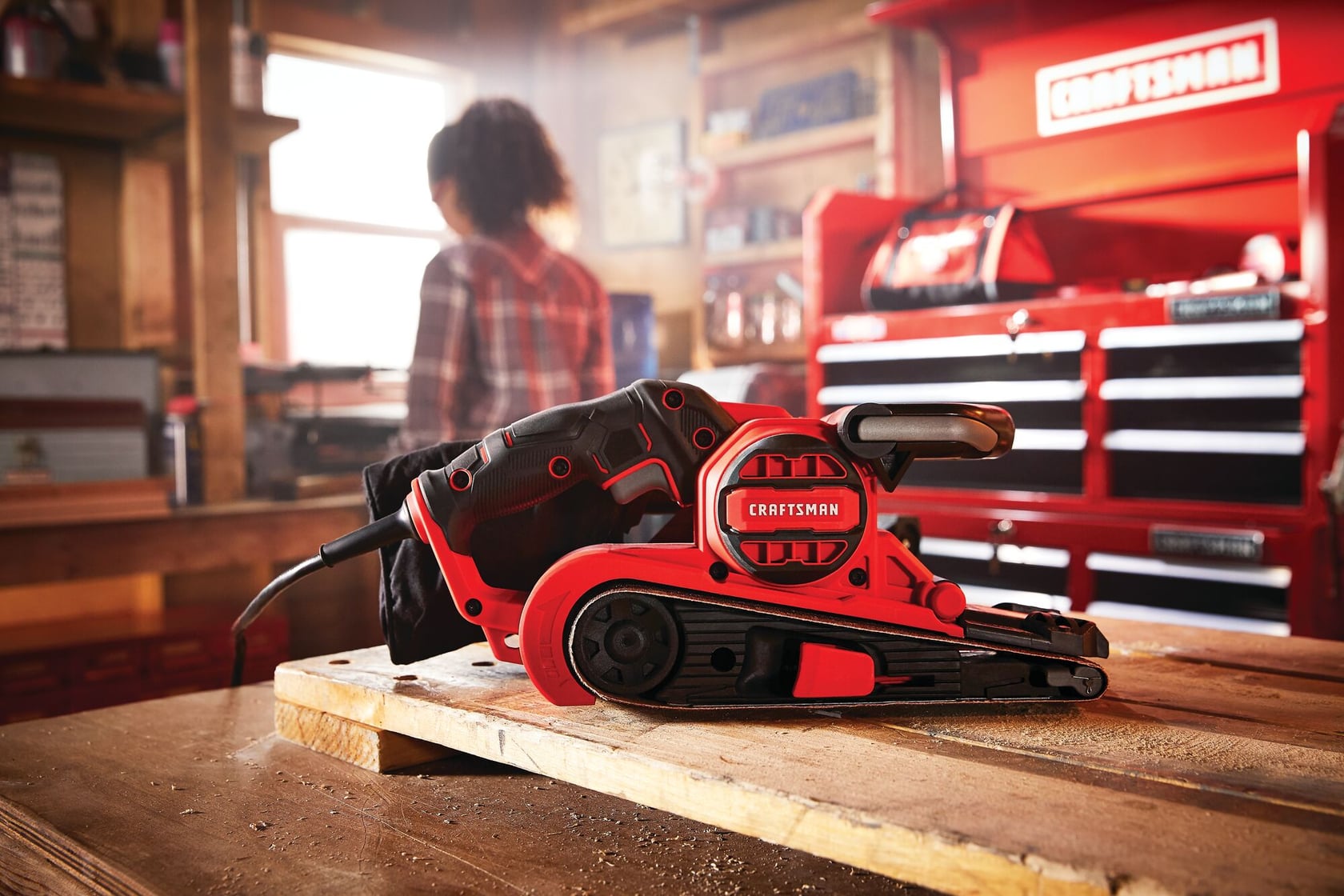 7 amp 3 inch by 21 inch belt sander on a work table.