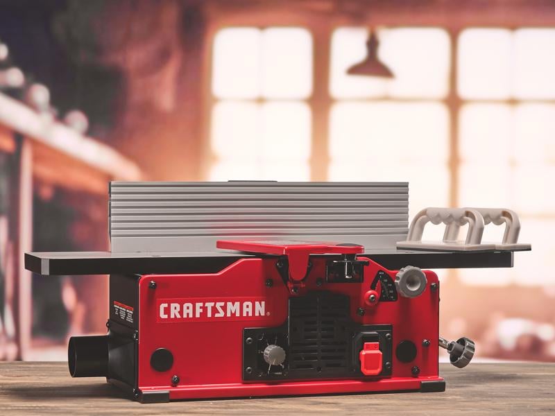 Photo of Craftsman jointer CMEW020, red body, tabletop angle, push handles on right side.