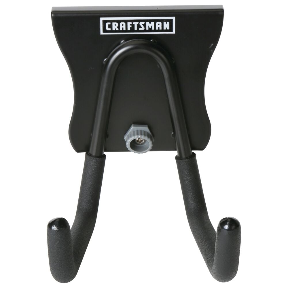 A black metal wall mount hook with two prongs, branded with the Craftsman logo. Designed for organizing tools or equipment.