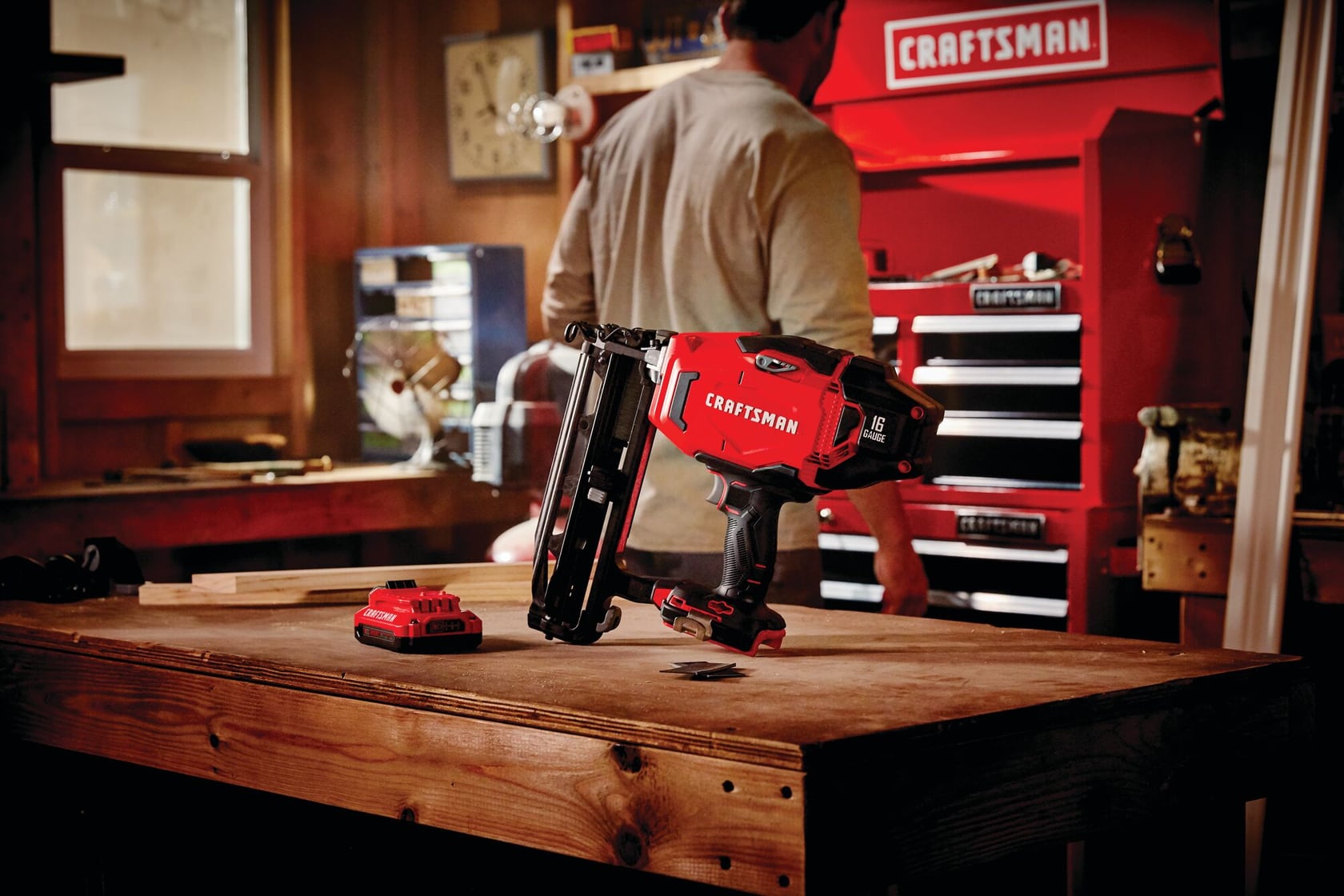 Photo of Craftsman CMCN616C1 cordless nailer and battery on a wooden workbench, with a Craftsman tool chest in the background.