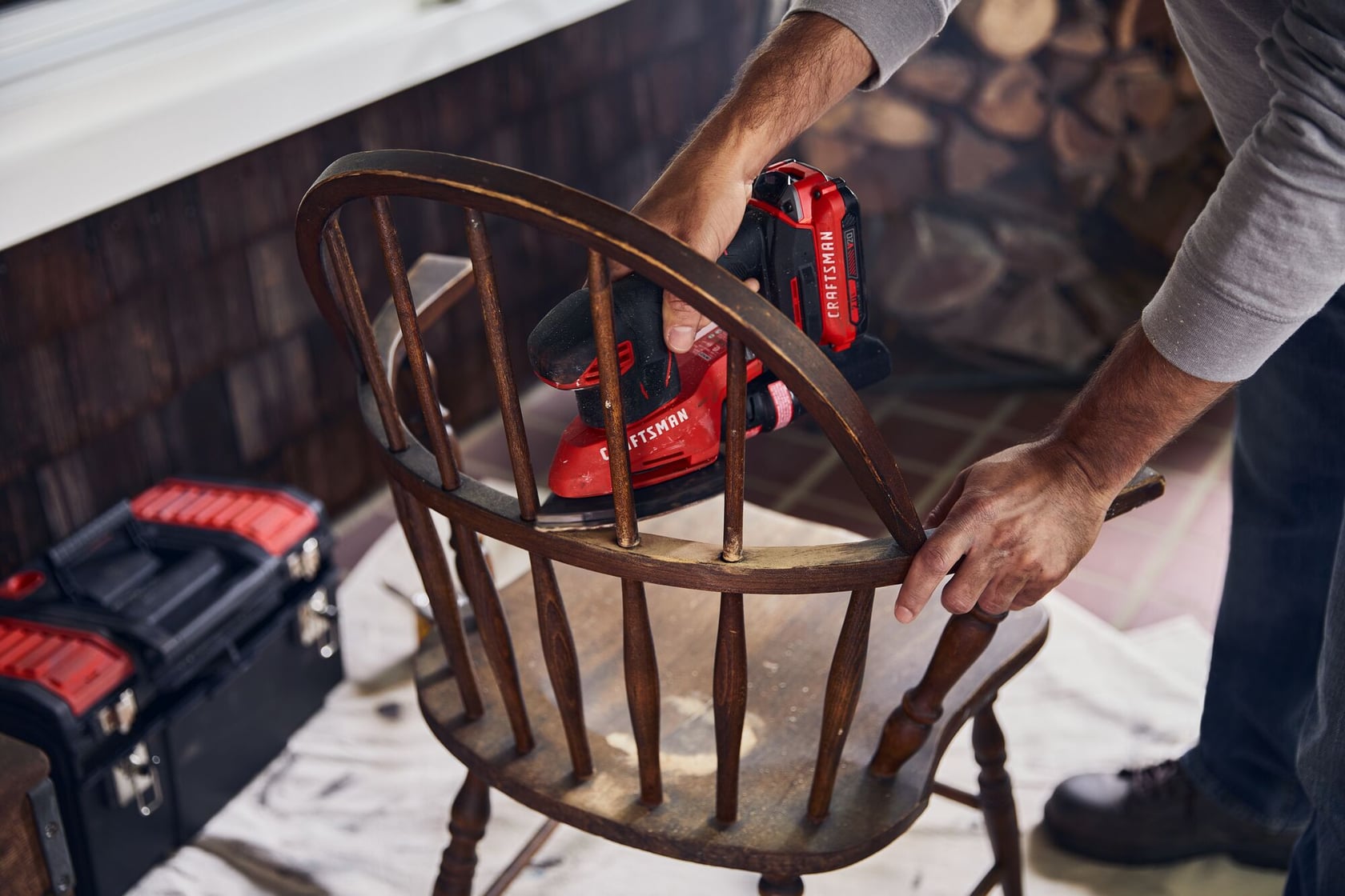 20 volt cordless detail sander being used.