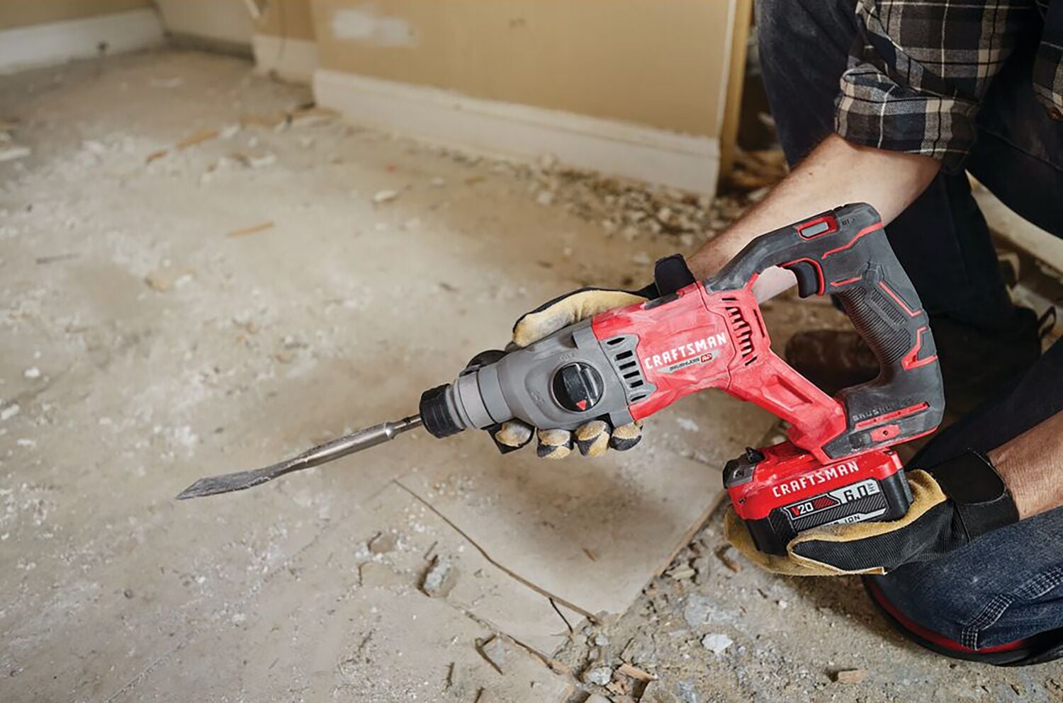 Man with gloves, respirator and safety glasses using the CRAFSTMAN V20 Brushless RP 7/8 inch SDS plus Rotary Hammer with to remove tile flooring.