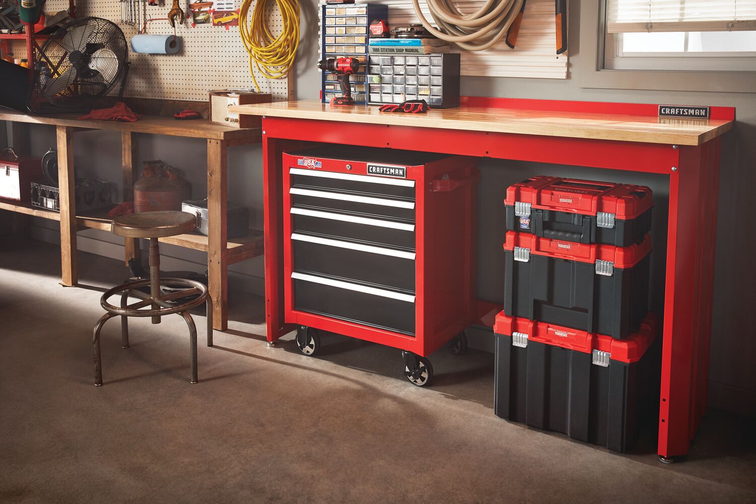 6 foot wide Workbench with Butcher Block Top accommodating tool cabinets chests and organizers under and on top of it in a garage workshop.