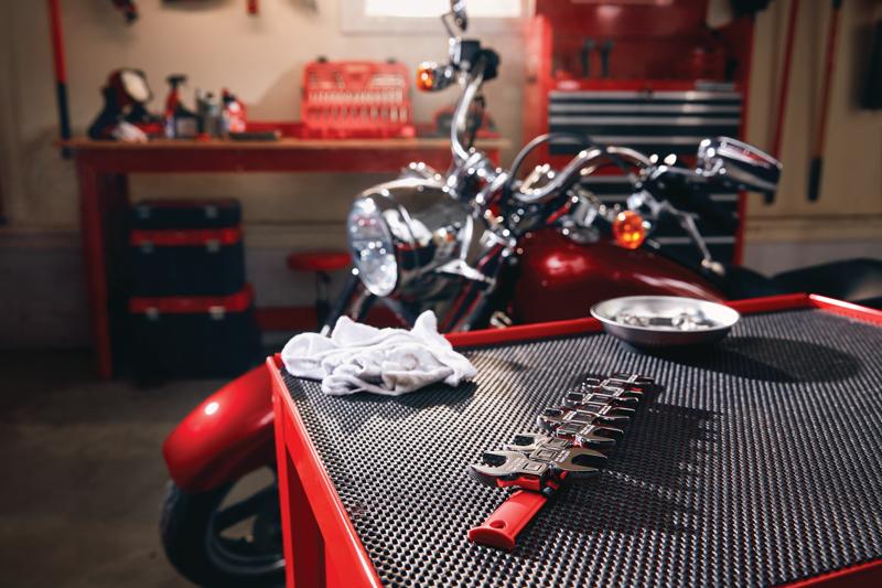 10 piece s a e crow foot wrench set placed on table in workshop.