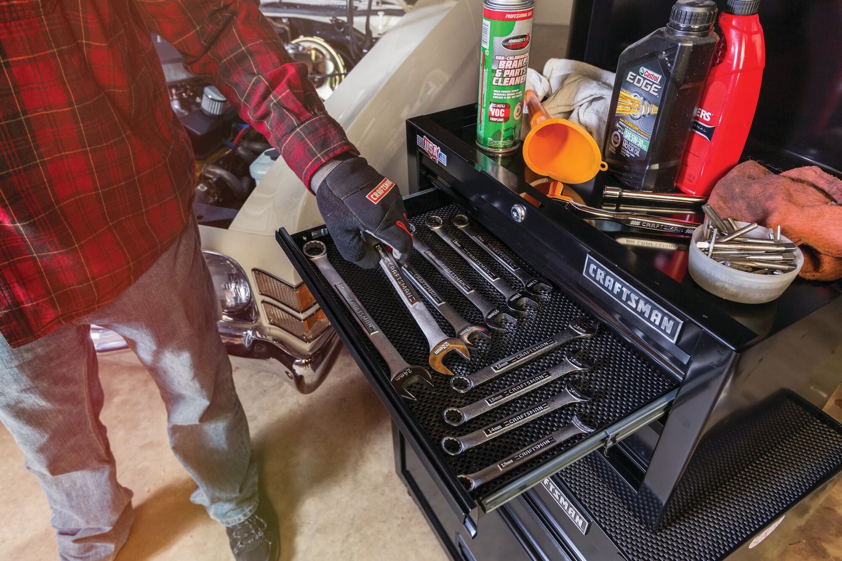 Photo of Craftsman CMST22653BK tool chest with open drawer holding wrenches, automotive supplies on top.