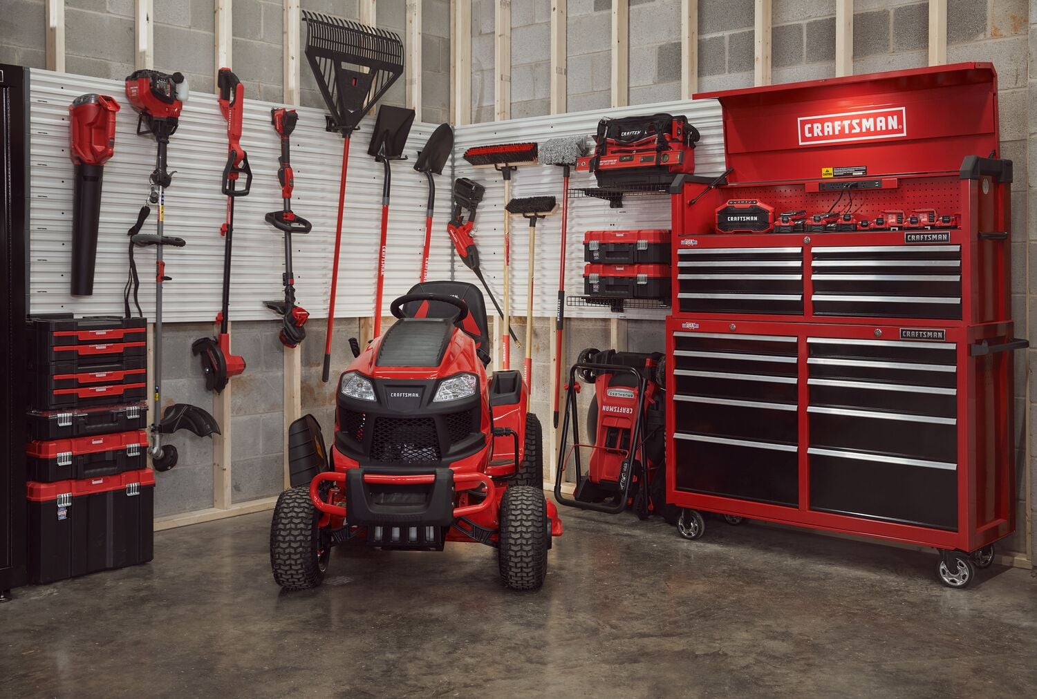 Craftsman garage setup with CMCBL700D1 tools, lawn mower, tool chest, and wall-mounted storage in red and black.