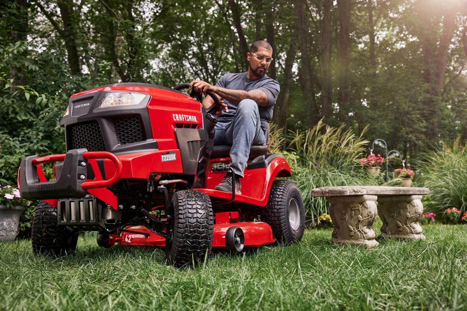 Photo of Craftsman red riding lawn mower CM13APA9ZSA93 in a garden setting, front side view with visible T2200X label.