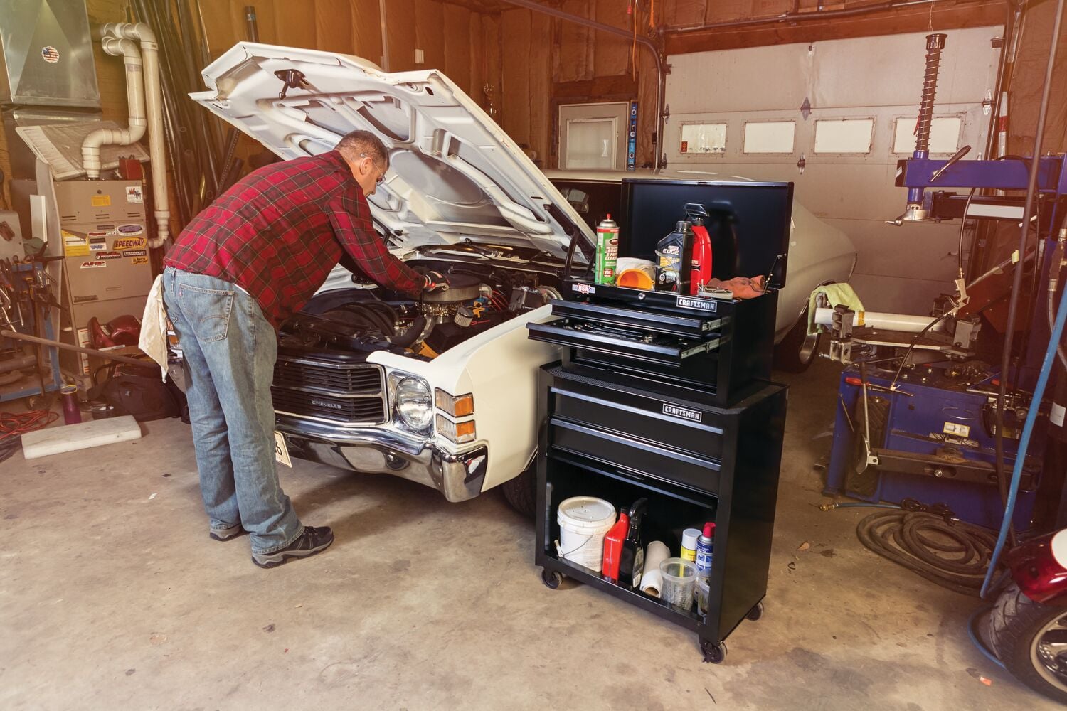 Photo of Craftsman CMST22653BK black tool chest in garage beside classic car, filled with tools and supplies.