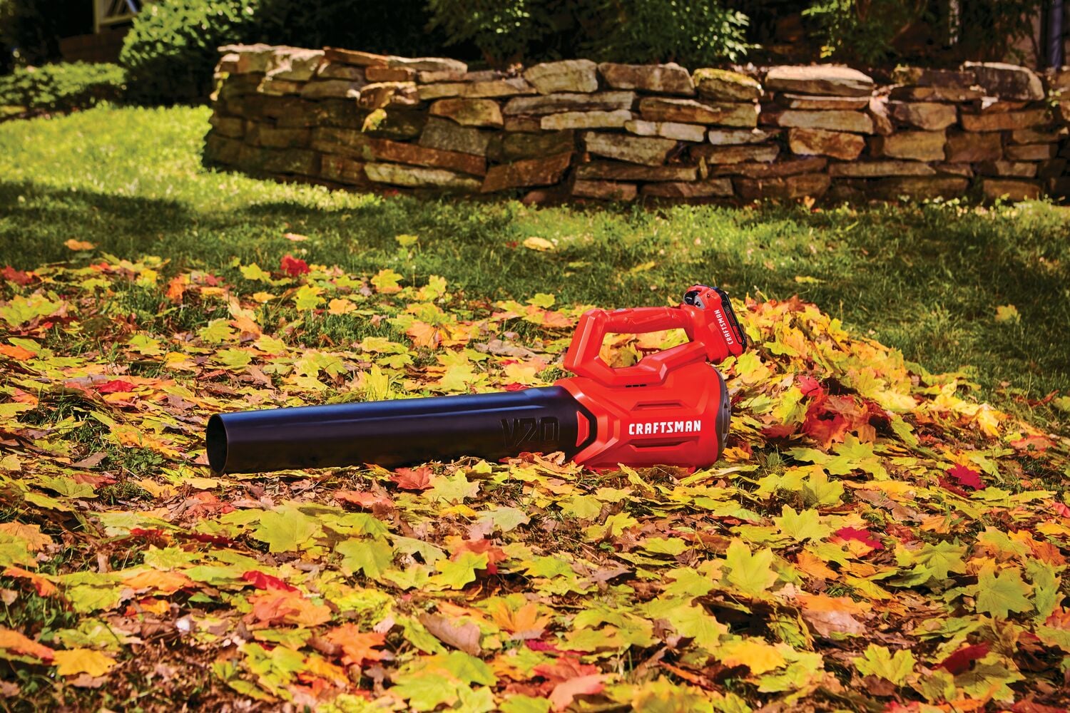 Cordless axial leaf blower kit 2 amp hour placed in lawn.