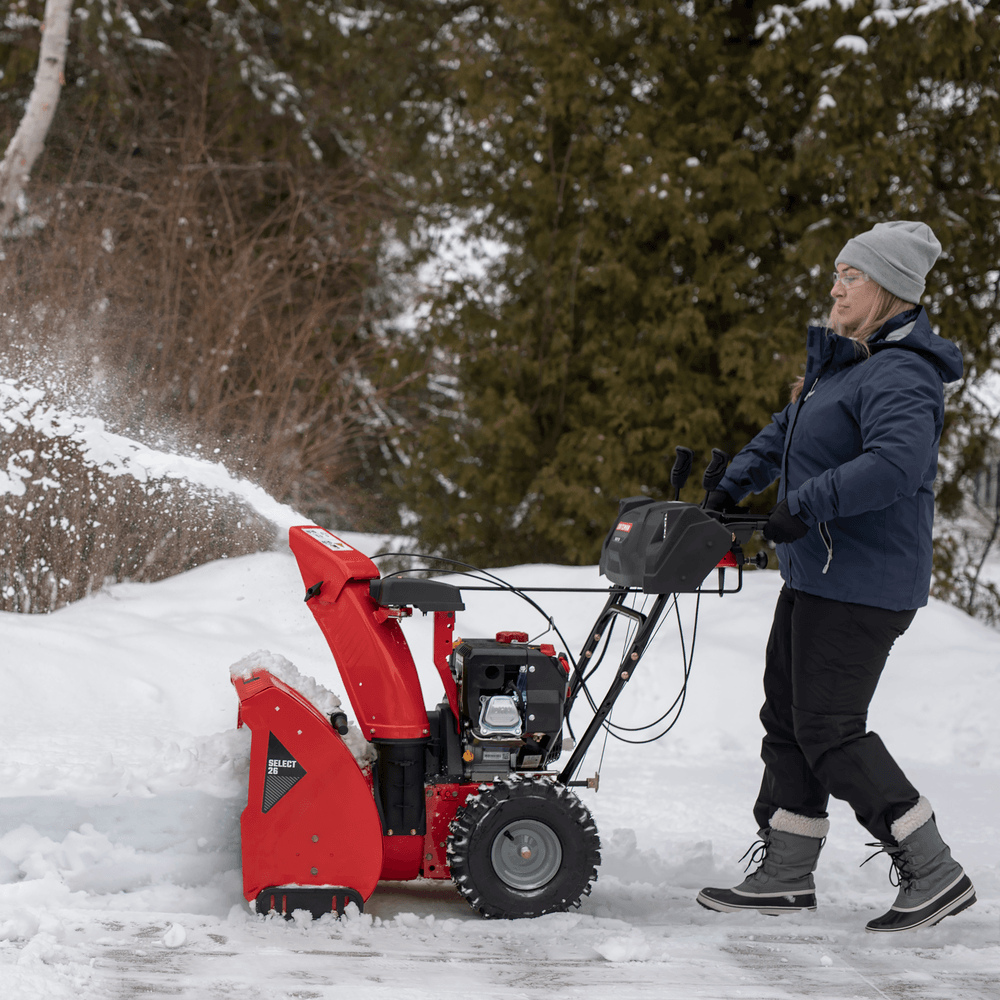 SELECT 26 inch 243 CC two stage gas snow blower with push button electric start being used.