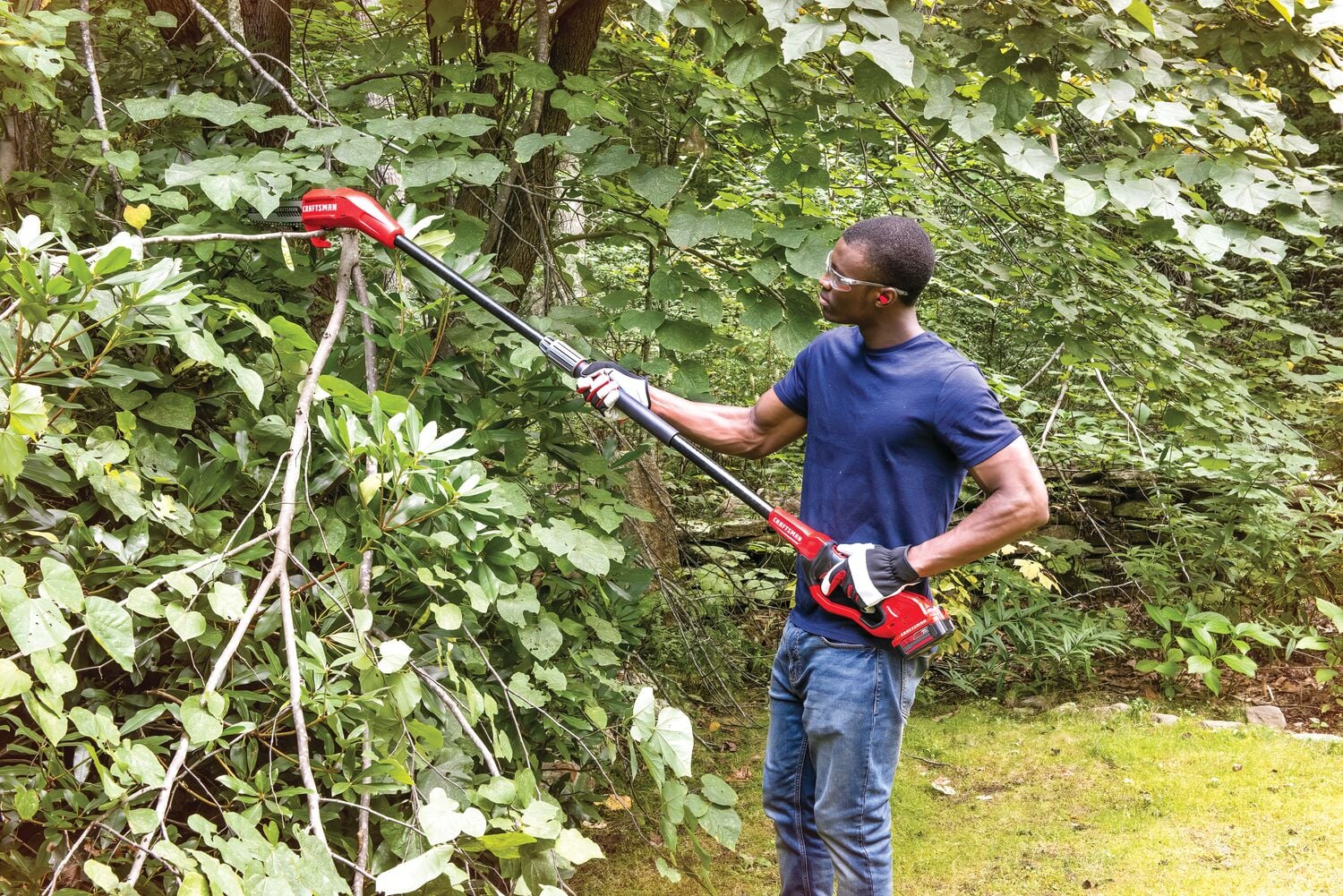 Photo of Craftsman pole saw CMCCSP20M1 in use cutting tree branches outdoors.
