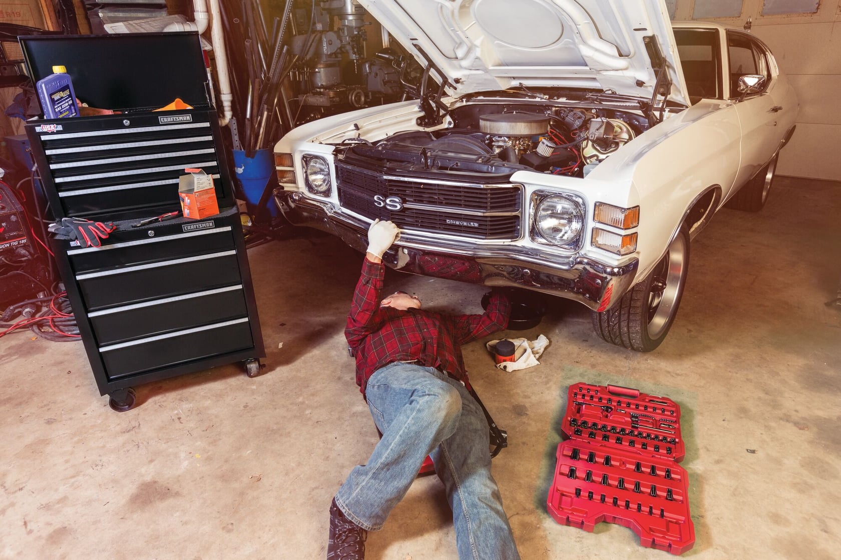 Photo of Craftsman black tool chest CMST22654BK in a garage, positioned beside a classic car and tool set on floor.