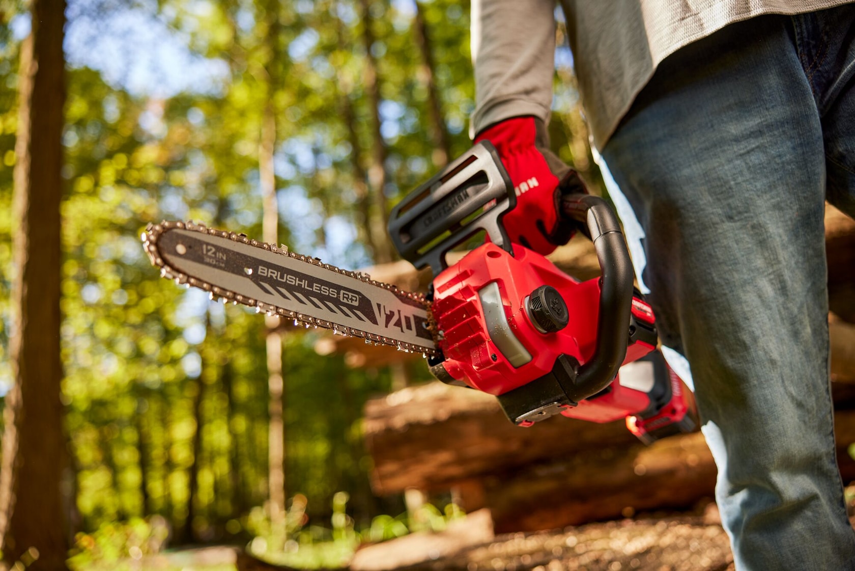 Zoom in of male holding V20 chainsaw