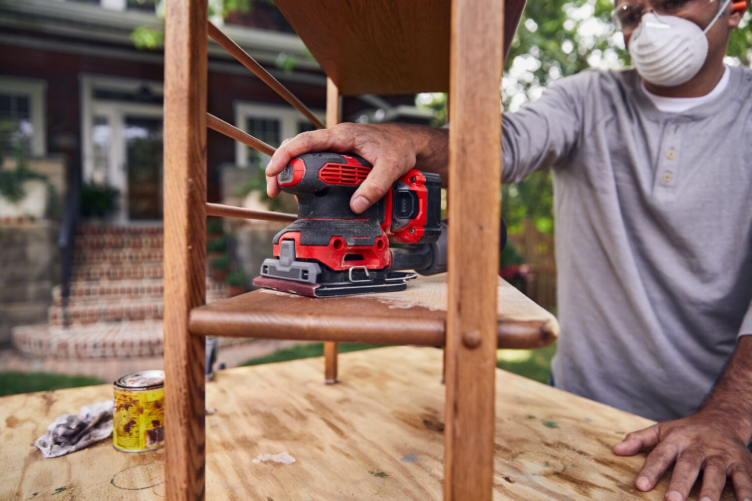 20 volt cordless quarter sheet sander in use.