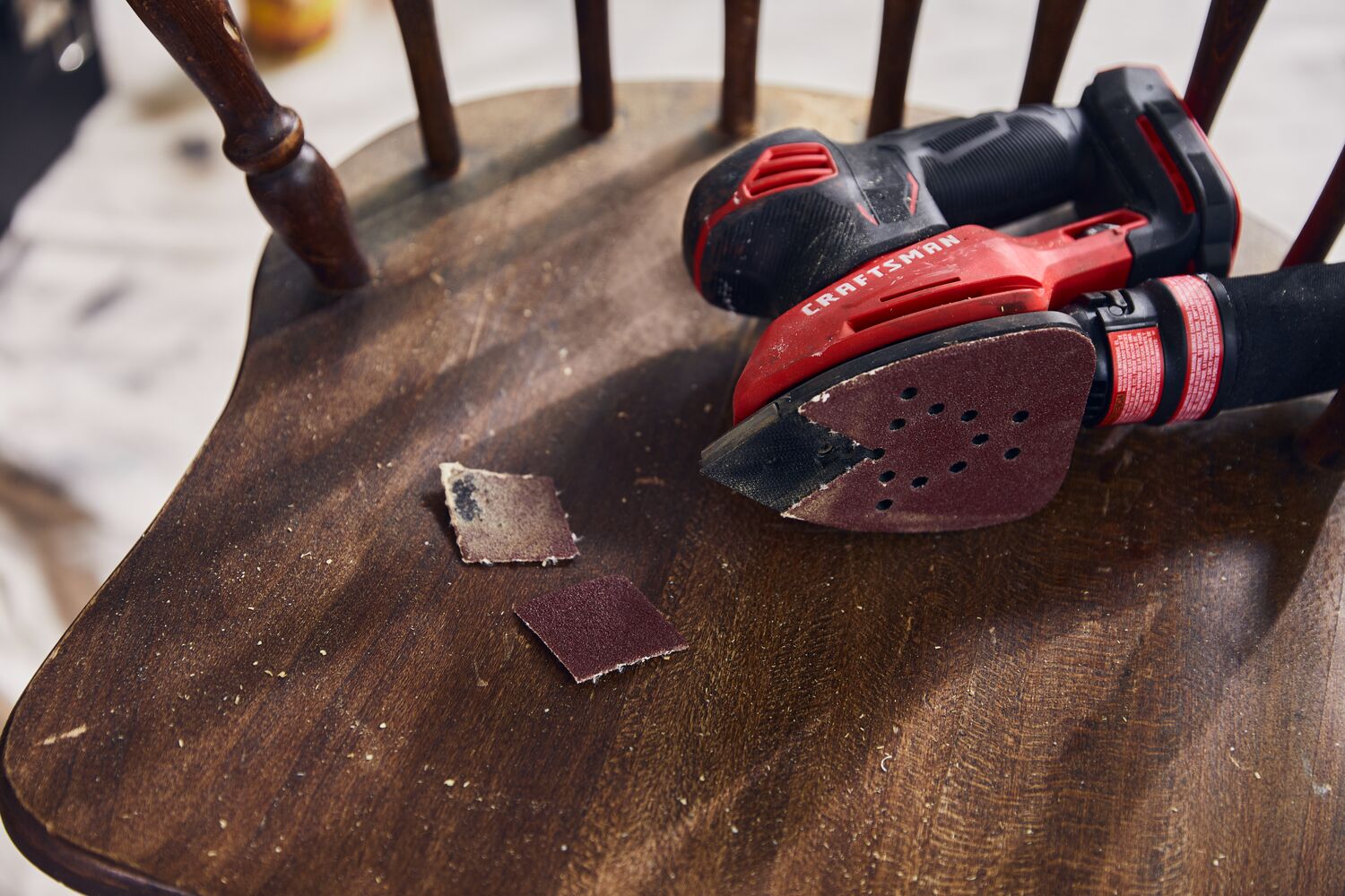 20 volt cordless detail sander in use.