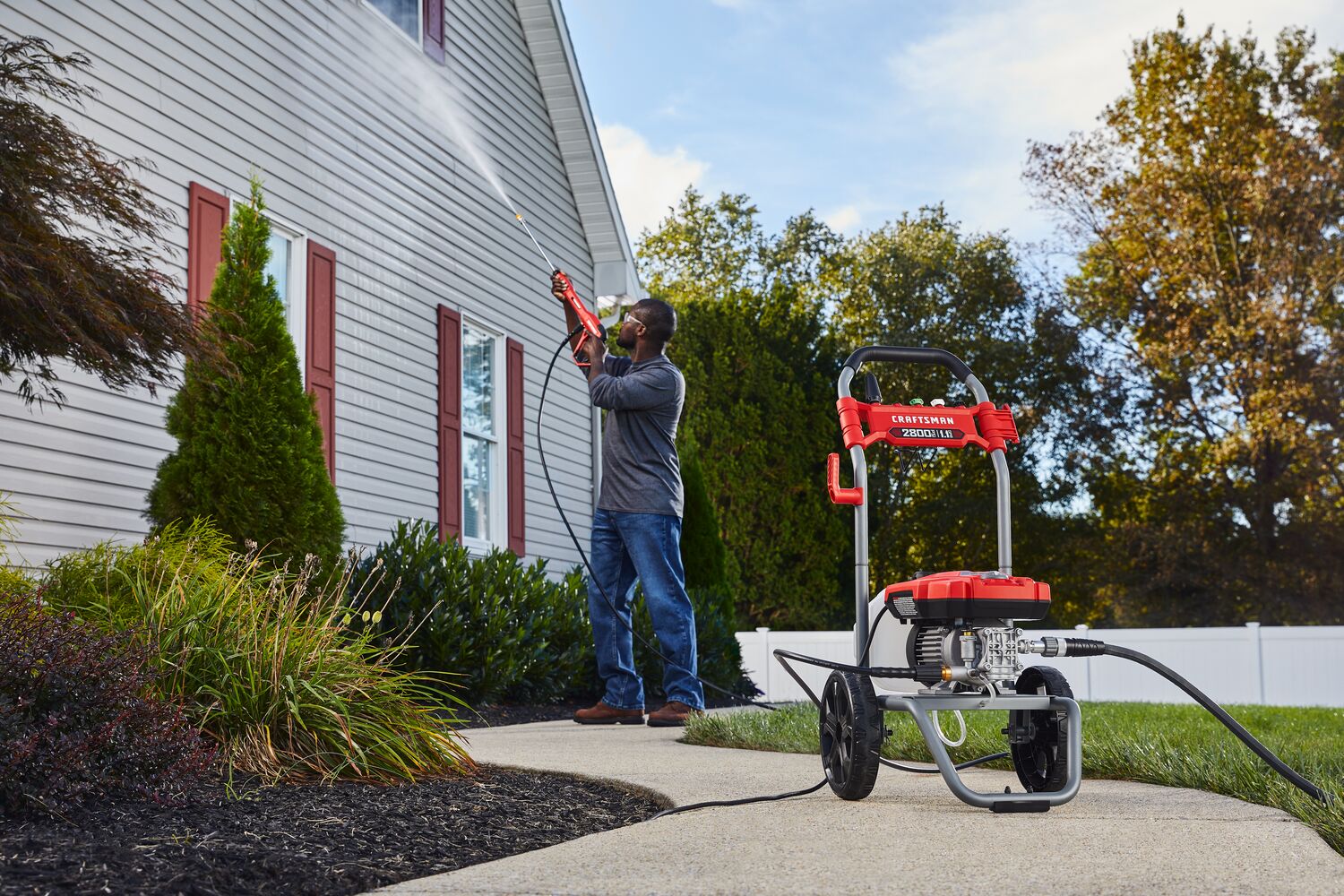 CRAFTSMAN 2800 Pressure Washer pressure washing second story of home with shrubs and fence