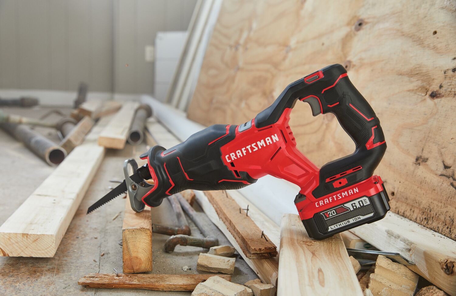 20 volt brushless cordless reciprocating saw with battery placed at wooden work station.
